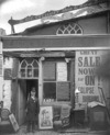 [George Deacon posing with a rifle outside the Old Curiosity Shop, Colbeck St. Waterford]