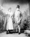 [Unidentified couple holding hands, full-length portrait]