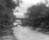 [Man in boat passing under Old Weir Bridge, Killarney, Co. Kerry]