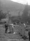 St. Kevin's Cross and Kitchen, Glendalough guide explaining to visitor how to receive good luck