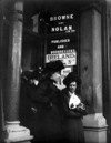 [Three women standing at the door of Browne and Nolan Limited, publisher and bookseller]