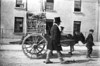 [Man and boy leading horse-drawn cart, advertising Ballyshannon show]