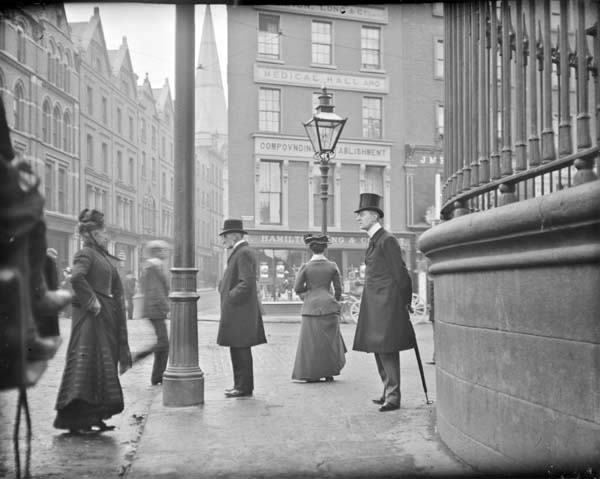 Man with umbrella standing at the junction of Nassau Street, Grafton Street and Suffolk Street. View from Nassau Street at the corner of&nbsp;...