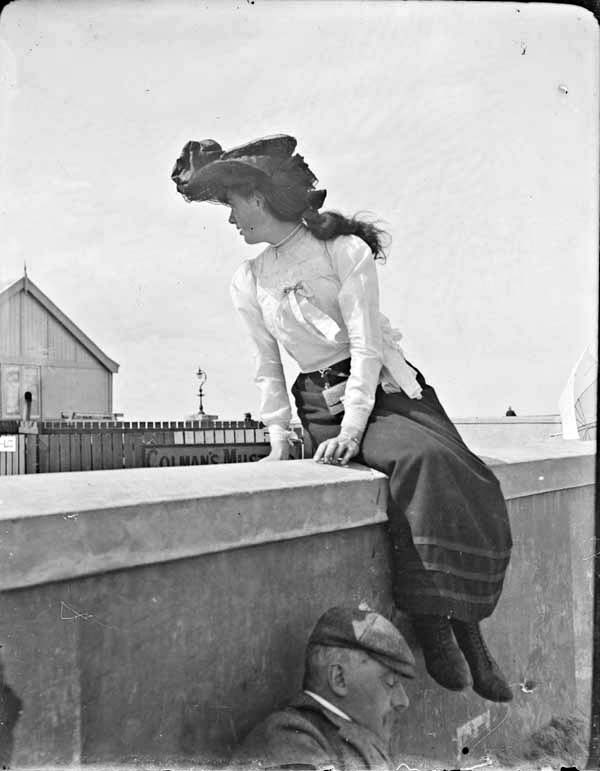 Woman sitting on a wall