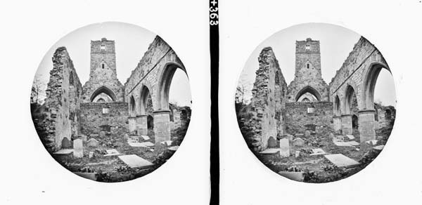 Ecclesiastical ruin, pointed arches, square tower centre, window of four ...