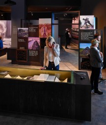 Interior of Seamus Heaney Listen Now Again exhibition with visitors looking at displays