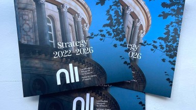 Three copies of the NLI's five-year strategy in a pile