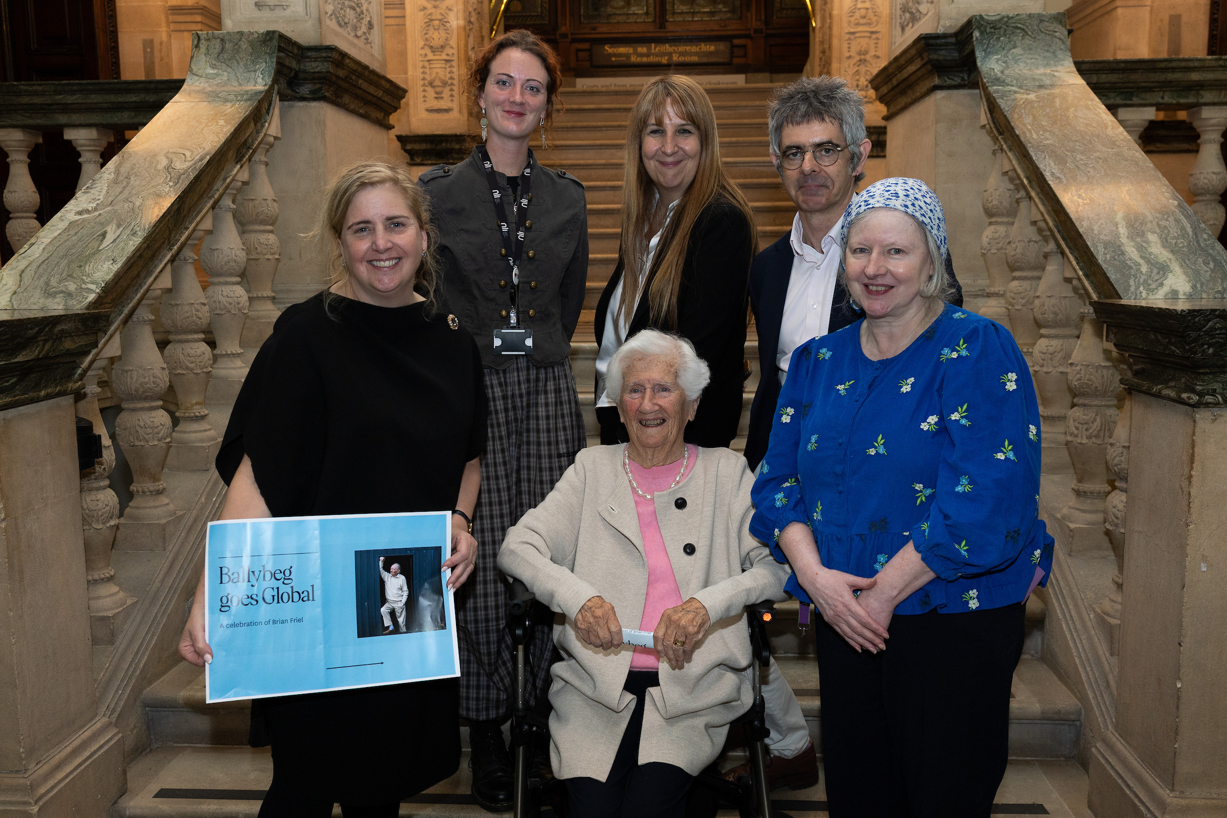NLI Brian Friel Day organisers pose with Virginie Roche-Tiengo (middle back) and Anne Friel (front center). Left to right: Sinéad McCoole (Head of Exhibitions, Learning and Programming); Anna Wallace Pitts;  Crónán Ó Doibhlin (Head of Special Collections); and Bríd O'Sullivan.