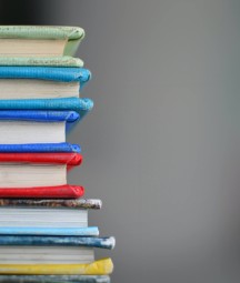 A stack of brightly coloured hardback books