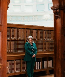 Image of Audrey Whitty under arch in reading room