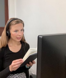 Woman with blonde hair looking at computer screen