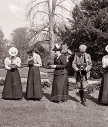 Women and men holding box cameras