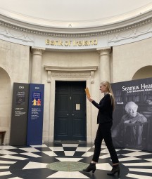 Colour photograph of woman walking through circular hallway.
