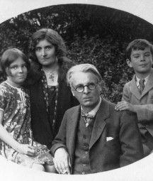 Black and white photograph of WB Yeats and his young family. From left to right , is his daughter Anne, his wife Georgie, WB Yeats and his son Michael.