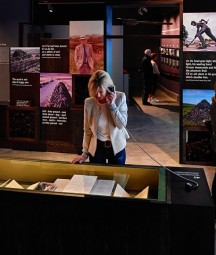 A photo showing the Heaney exhibition with people enjoying the exhibitions