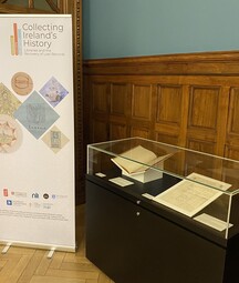A glass display case with roll up banner