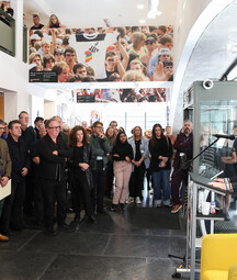 Man speaking from a lectern to a group of people