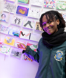 photo of young girl pointing to postcards