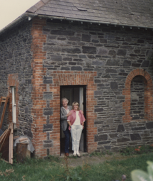a photo of heaney and marie standing in the doorway of their house in Glanmore