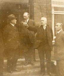 The members of the Boundary Commission standing in a line outside at its first sitting.