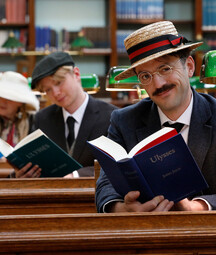Three people reading Ulysses inside the NLI's reading room