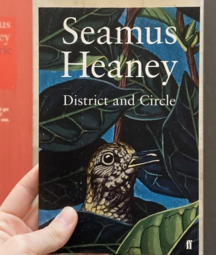The book district and circle held up in front of exhibition displays