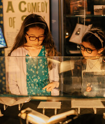 children looking at a display case in the exhibition 