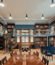 View of the Art Room at the National Library of Ireland. Upper level, with bookcases and blue sofas.