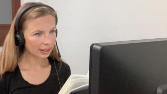 Woman with blonde hair looking at computer screen