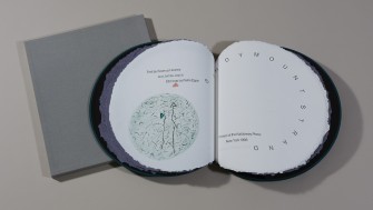 Photo of circular book with hand-coloured etchings showing the words 'Sandymount Strand'. 