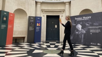 Colour photograph of woman walking through circular hallway.