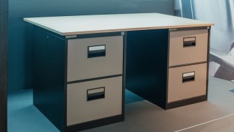 Photograph of a grey and brown desk.