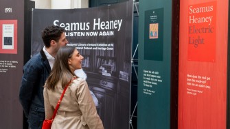 a young man and woman reading seamus heaney listen now again signage 
