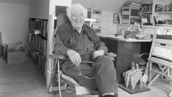 Seamus Heaney sitting in his chair in this office