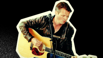 A musician sitting and playing an acoustic guitar, wearing a black leather jacket and jeans, with a microphone positioned in front of him. The image has a vintage, grainy appearance with a cream-coloured cut-out border against a black background.