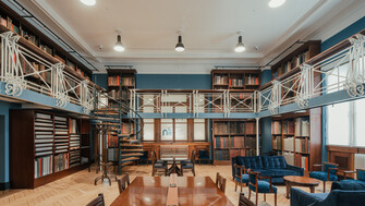 View of the Art Room at the National Library of Ireland. Upper level, with bookcases and blue sofas.