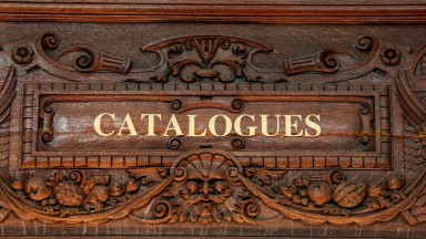 Close up of text written above a doorway reading 'Catalogues'