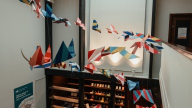 Paper bird decorations in the vestibule of the Seamus Heaney Listen Now Again Exhibition