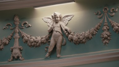 A moulded cherub in the detail of the NLI Main Reading Room decorations