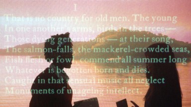 Image of students behind screen of text inside the Yeats exhibition at the NLI