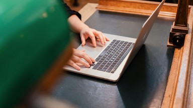 Person's hands typed on a computer keyboard