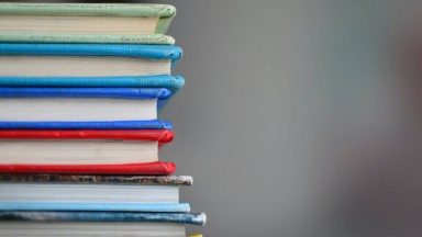 A stack of brightly coloured hardback books