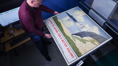 Image of staff photographing large scale print