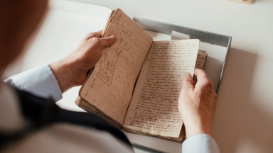 Hands holding a book in a box