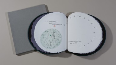 Photo of circular book with hand-coloured etchings showing the words 'Sandymount Strand'.