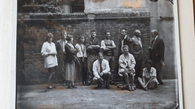 Black and white group photo of NLI staff in the courtyard