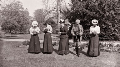 Women and men holding box cameras