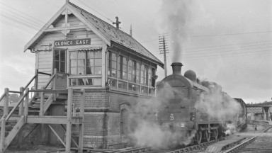 Image from Co. Monaghan is of the ‘Goods train’ at Clones East in July 1959. The photograph showcases a steam train passing the signal cabin. 