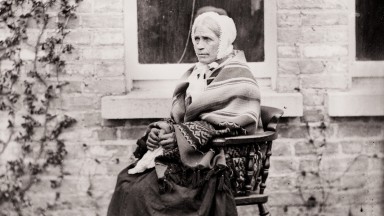 Portrait of servant woman, known as widow kelly, seated outside the photograph house, Clonbrock, Co.Galway