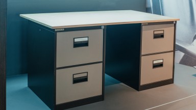 Photograph of a grey and brown desk.